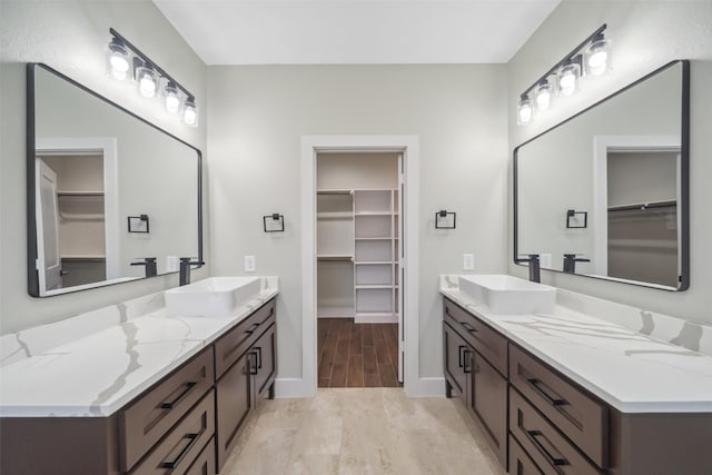 443 Wellshire Dr, West Columbia, TX 77486 - full bath with a spacious closet, two vanities, and a sink