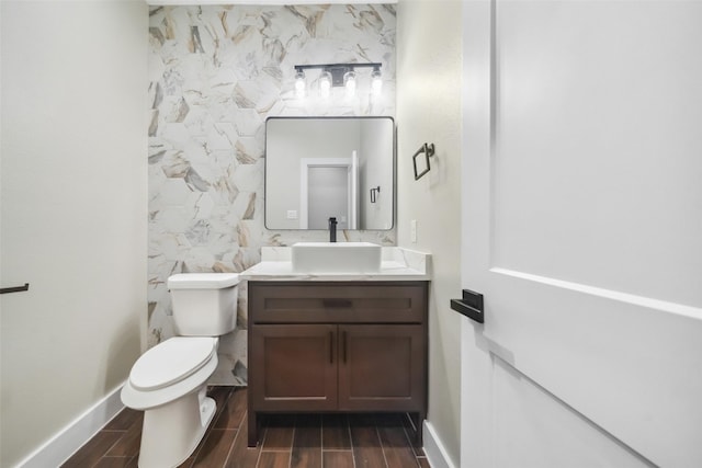 443 Wellshire Dr, West Columbia, TX 77486 - bathroom featuring vanity, toilet, wood tiled floor, and baseboards
