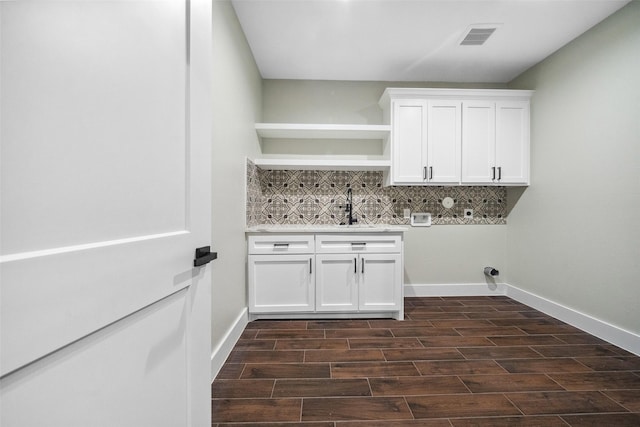 443 Wellshire Dr, West Columbia, TX 77486 - laundry area with a sink, cabinet space, washer hookup, visible vents, and dark wood-style floors