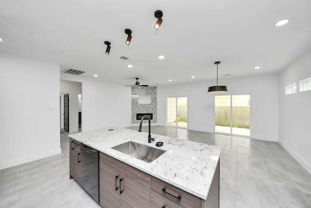 kitchen featuring a sink, black dishwasher, open floor plan, recessed lighting, and baseboards