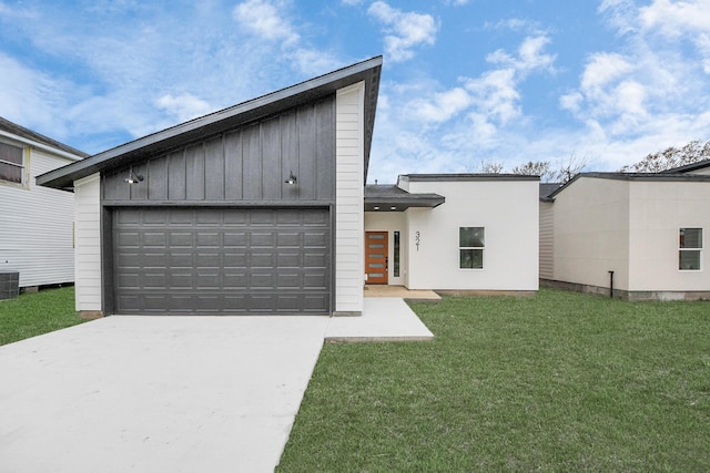 view of front of home featuring board and batten siding, a garage, driveway, central air condition unit, and a front yard