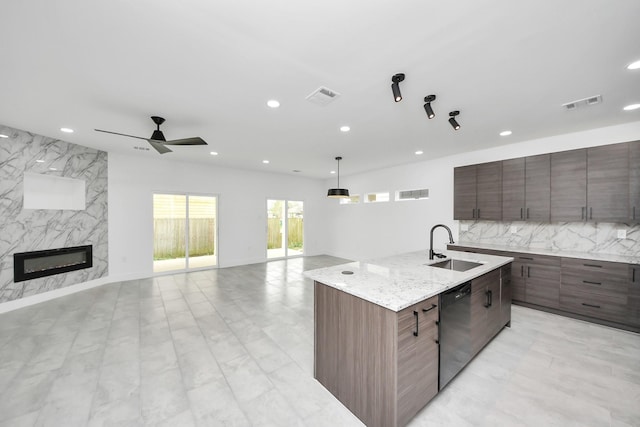 kitchen featuring black dishwasher, a sink, open floor plan, recessed lighting, and modern cabinets