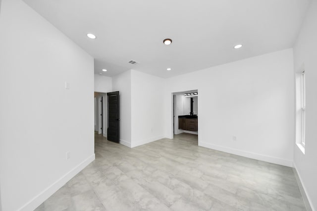 unfurnished room with recessed lighting and baseboards
