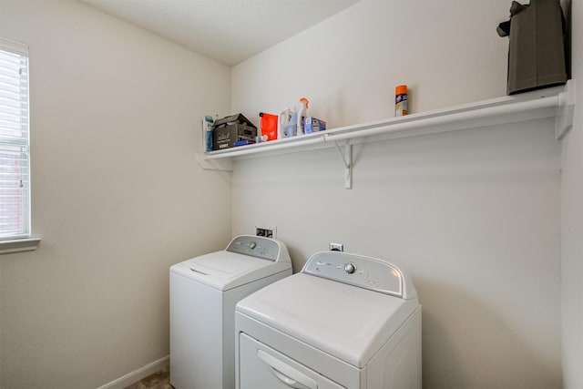 washroom with washing machine and clothes dryer and laundry area