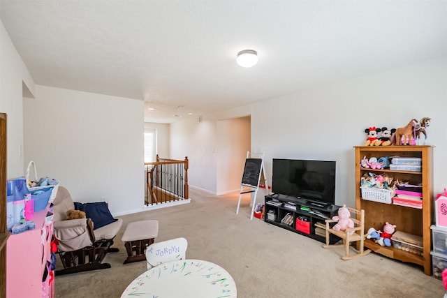 rec room with baseboards and carpet floors