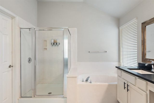 bathroom featuring a bath, vanity, and a shower stall