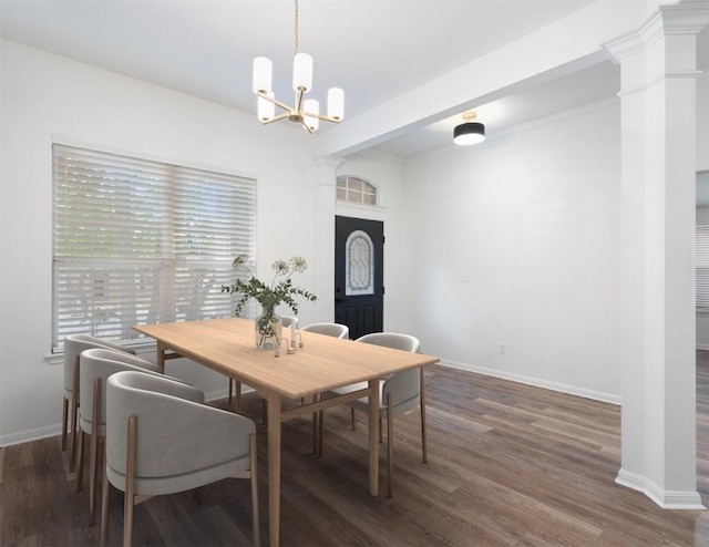 dining room featuring an inviting chandelier, wood finished floors, baseboards, and ornate columns