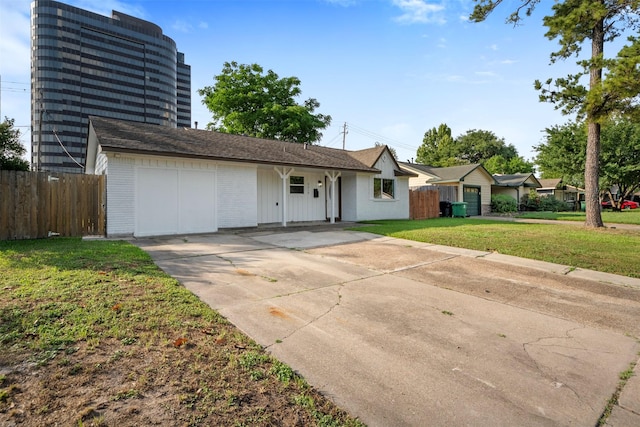 ranch-style home with driveway, a front lawn, and fence