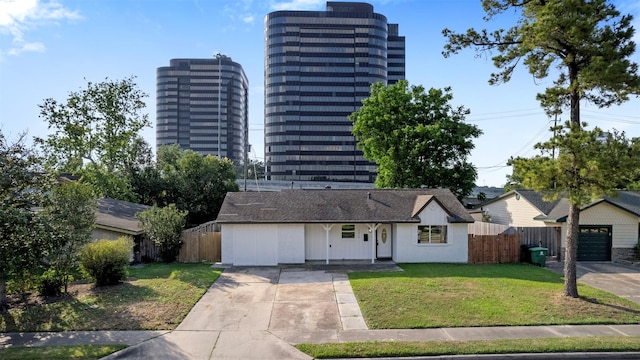 exterior space with fence, a garage, and driveway