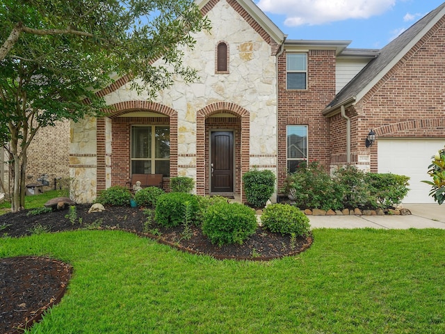 view of front facade with a front lawn, brick siding, and stone siding