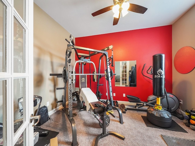 exercise room with baseboards and ceiling fan