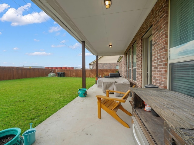 view of patio / terrace with a hot tub and a fenced backyard