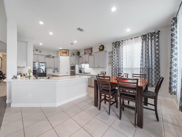dining space with light tile patterned floors, visible vents, and recessed lighting