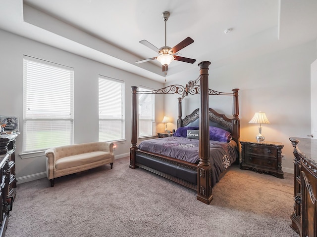 bedroom featuring baseboards, ceiling fan, and light colored carpet