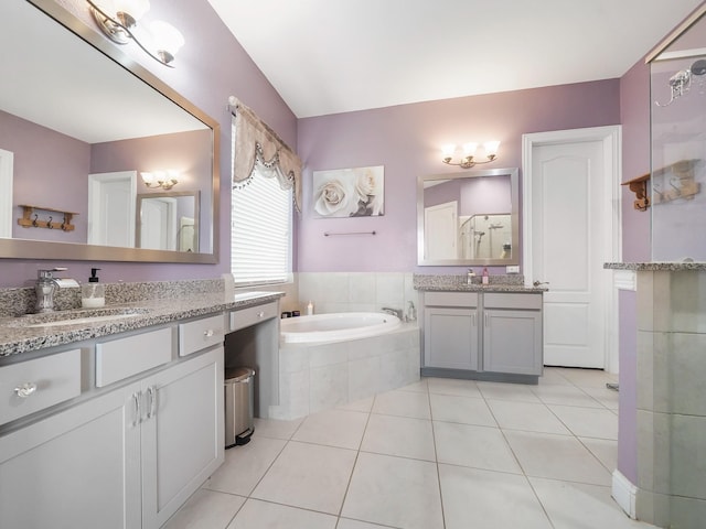 full bathroom featuring a sink, a stall shower, tile patterned flooring, two vanities, and a garden tub