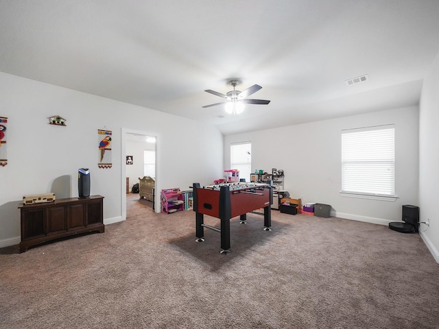 rec room featuring baseboards, carpet floors, a ceiling fan, and visible vents