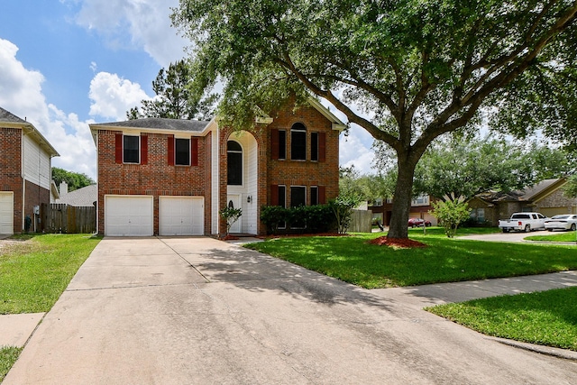 traditional-style house with concrete driveway, a garage, brick siding, and a front yard