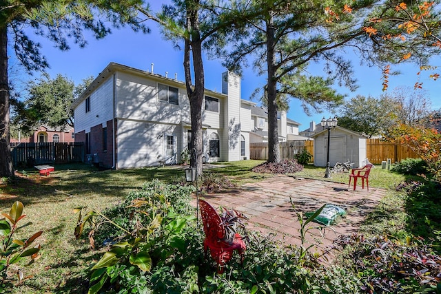 view of yard featuring a storage shed, an outdoor structure, and a fenced backyard