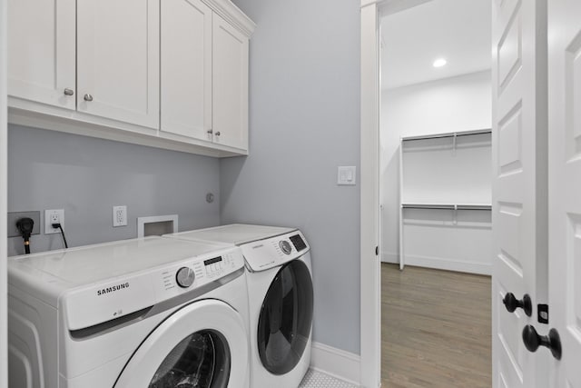 laundry room with recessed lighting, baseboards, wood finished floors, washer and clothes dryer, and cabinet space