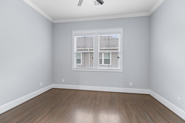spare room with dark wood-style floors, crown molding, baseboards, and a ceiling fan