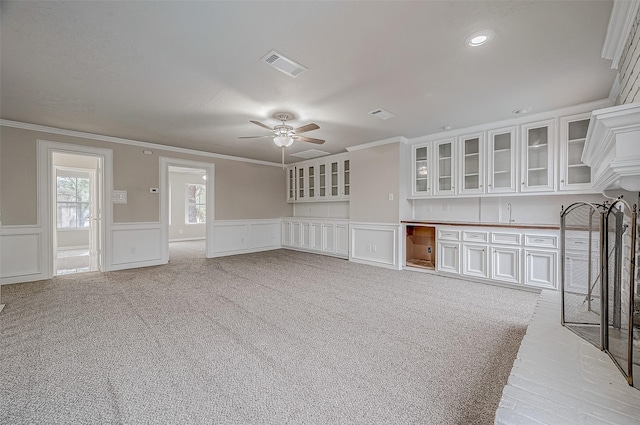 4218 Bayglen Ct, Houston, TX 77068 - unfurnished living room featuring ceiling fan, ornamental molding, light colored carpet, and visible vents