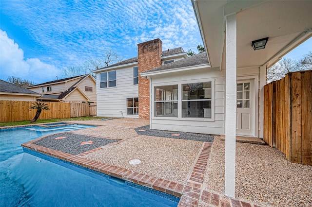 4218 Bayglen Ct, Houston, TX 77068 - rear view of property featuring a patio, a chimney, a shingled roof, a fenced backyard, and a fenced in pool