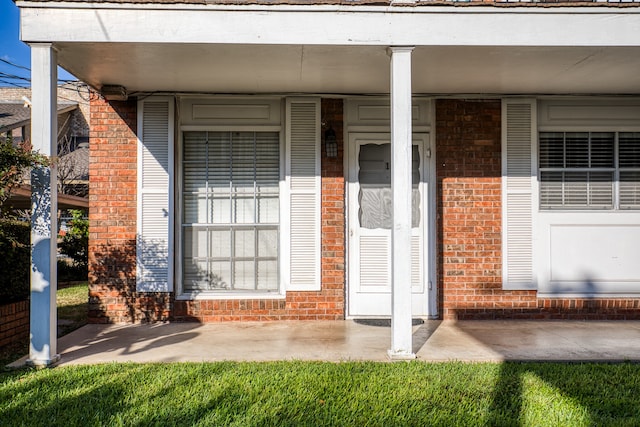 401 E Main St, Brenham, TX 77833 - view of exterior entry featuring brick siding