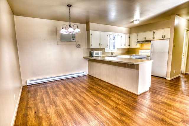 401 E Main St, Brenham, TX 77833 - kitchen with white appliances, a baseboard heating unit, under cabinet range hood, a peninsula, and wood finished floors