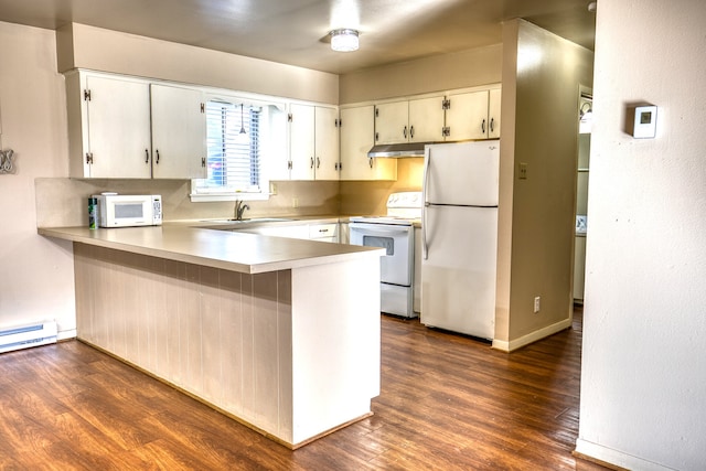 401 E Main St, Brenham, TX 77833 - kitchen with white appliances, a peninsula, dark wood-type flooring, light countertops, and under cabinet range hood