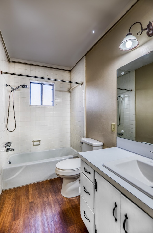 401 E Main St, Brenham, TX 77833 - full bath with toilet, wood finished floors, bathtub / shower combination, and vanity