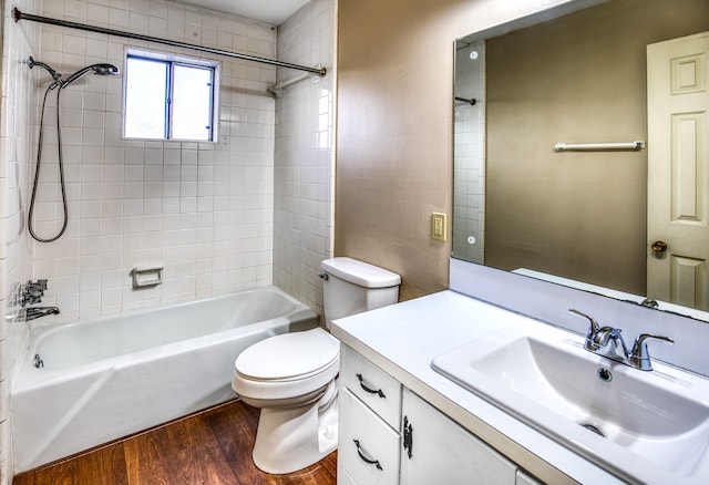 401 E Main St, Brenham, TX 77833 - bathroom with wood finished floors, toilet, shower / bathtub combination, and vanity