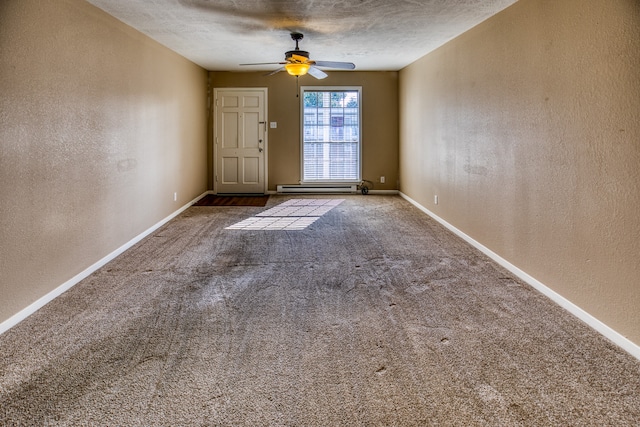 401 E Main St, Brenham, TX 77833 - empty room featuring a textured wall, ceiling fan, carpet floors, baseboards, and a textured ceiling