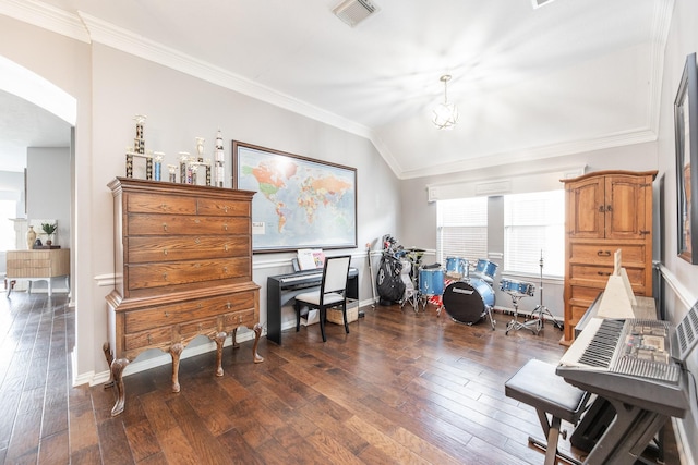 home office with crown molding, visible vents, hardwood / wood-style floors, and arched walkways