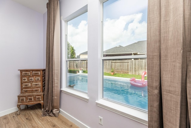 entryway featuring a wealth of natural light, wood finished floors, and baseboards