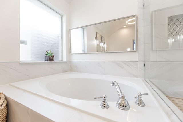 full bath featuring a bath and plenty of natural light