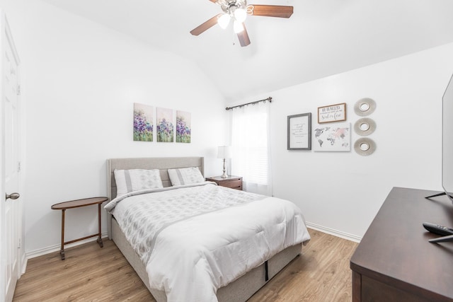 bedroom featuring vaulted ceiling, baseboards, a ceiling fan, and light wood-style floors