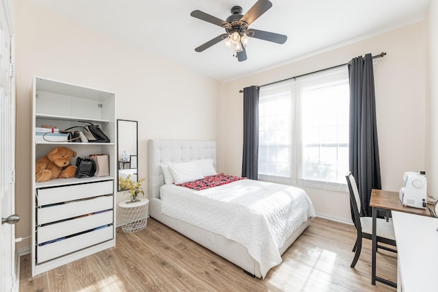 bedroom with baseboards, light wood-style floors, and ceiling fan