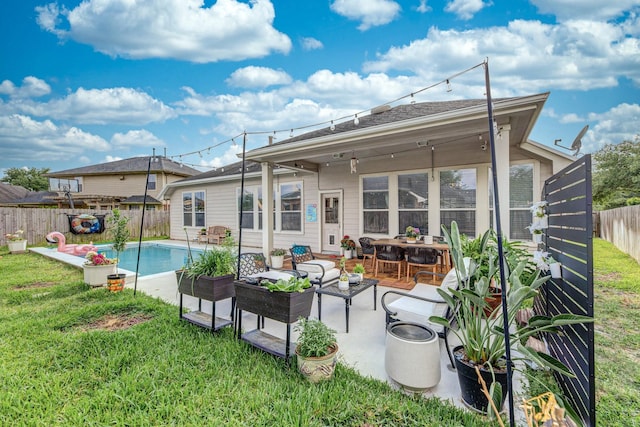 back of house featuring a lawn, a patio area, and a fenced backyard