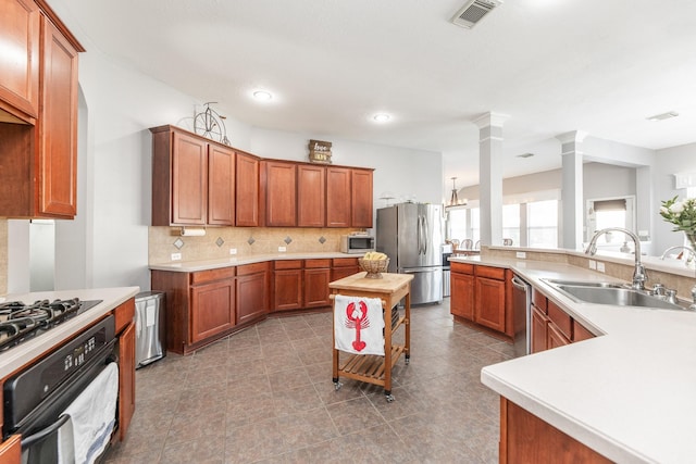 kitchen featuring a sink, stainless steel appliances, light countertops, and decorative backsplash