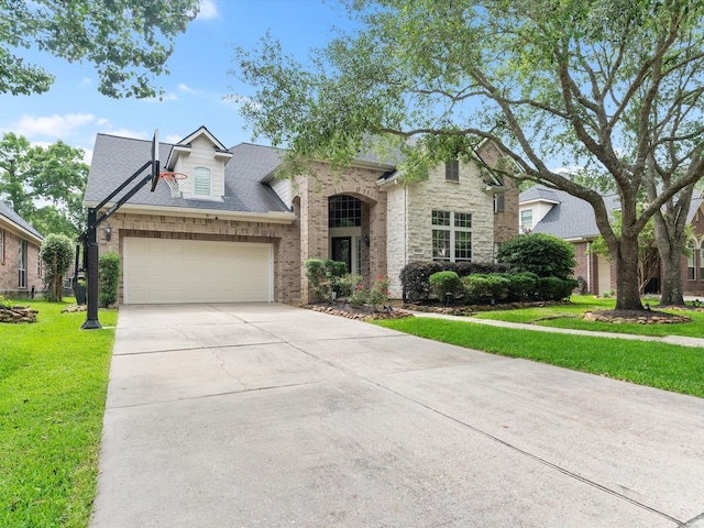 french provincial home with brick siding, a garage, a shingled roof, concrete driveway, and a front yard