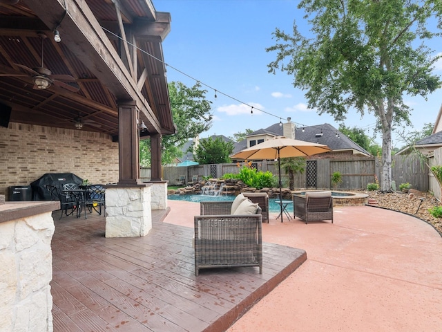 view of patio with a fenced backyard, area for grilling, a fenced in pool, and a ceiling fan