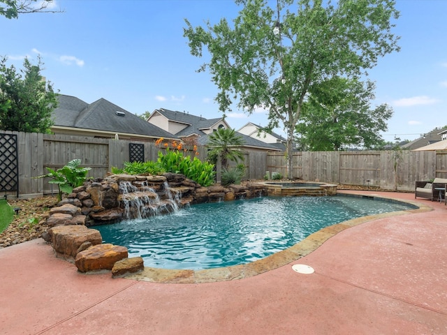 view of swimming pool featuring a patio, a pool with connected hot tub, and a fenced backyard