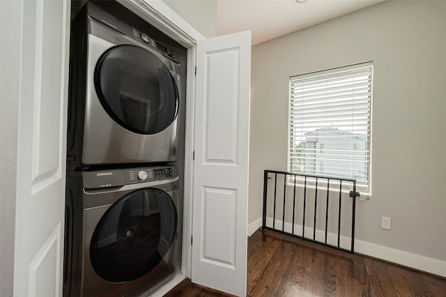 2424 Hadley St, Houston, TX 77003 - clothes washing area featuring laundry area, dark wood-type flooring, baseboards, and stacked washer / drying machine