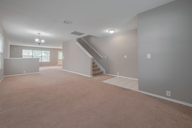 14910 Sugar Crystal Ct, Sugar Land, TX 77498 - unfurnished living room featuring light carpet, stairs, a notable chandelier, and visible vents