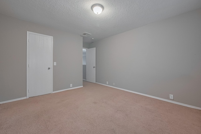 14910 Sugar Crystal Ct, Sugar Land, TX 77498 - unfurnished bedroom with light carpet, a textured ceiling, baseboards, and visible vents