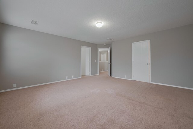 14910 Sugar Crystal Ct, Sugar Land, TX 77498 - spare room with baseboards, light carpet, visible vents, and a textured ceiling