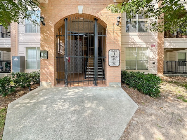 8051 Bay Branch Dr Unit 131, The Woodlands, TX 77382 - doorway to property with a gate and brick siding