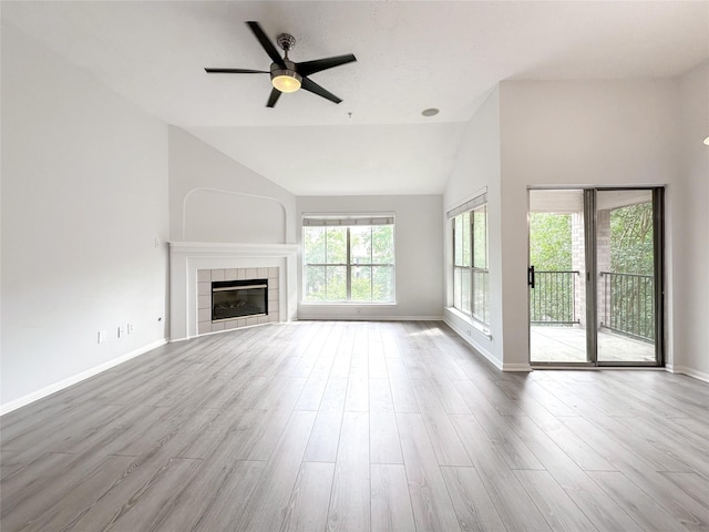 8051 Bay Branch Dr Unit 131, The Woodlands, TX 77382 - unfurnished living room with baseboards, vaulted ceiling, ceiling fan, and wood finished floors