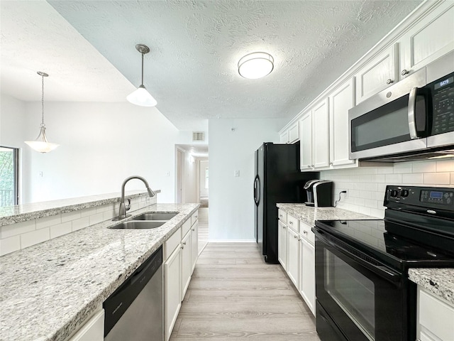 8051 Bay Branch Dr Unit 131, The Woodlands, TX 77382 - kitchen with white cabinetry, stainless steel appliances, tasteful backsplash, and a sink