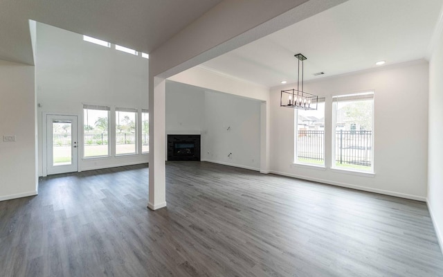 8406 Crab Blossom Dr, Cypress, TX 77433 - unfurnished living room featuring baseboards, a notable chandelier, a fireplace, and crown molding